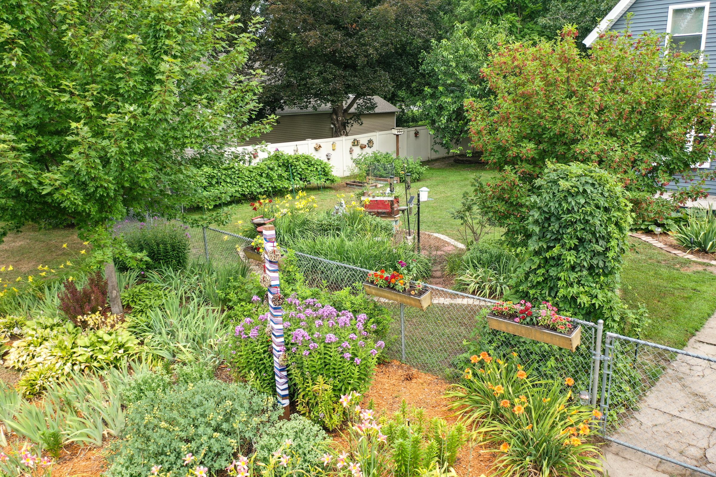 yard with multiple shrubs and flowers in bloom