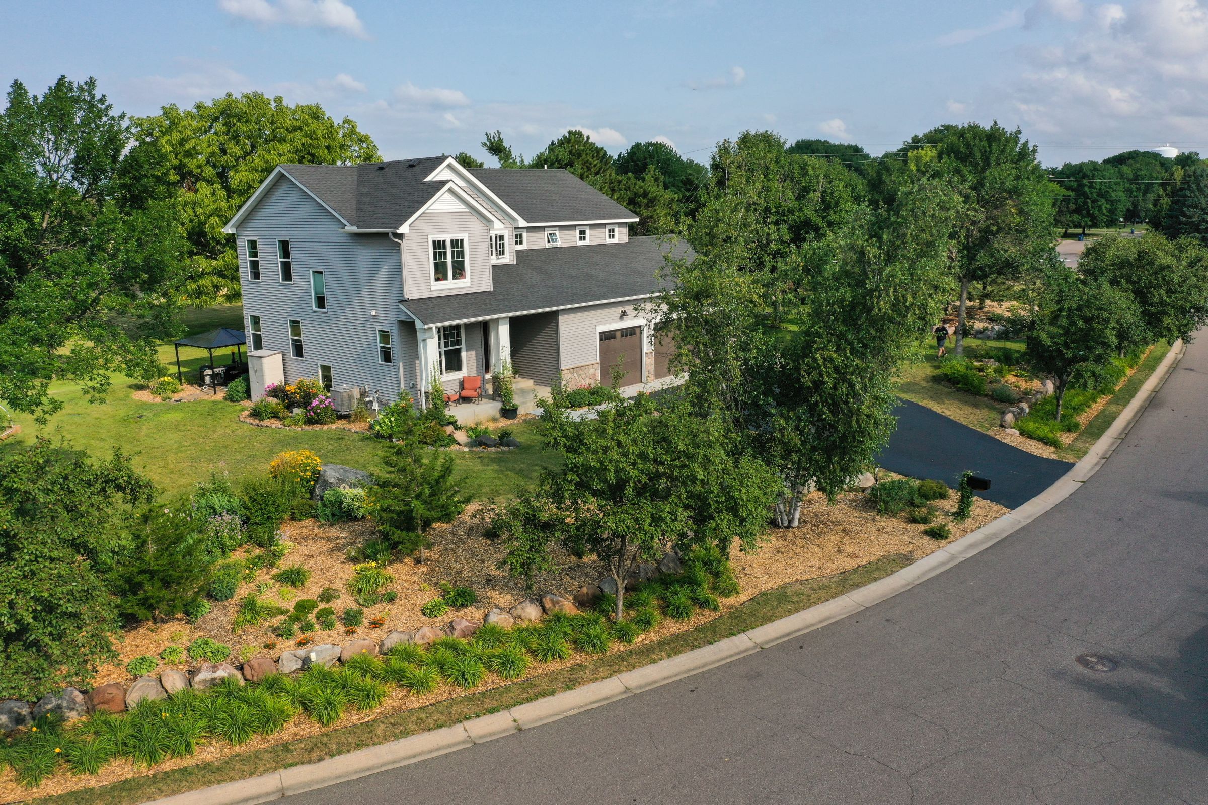 high angle view of house and front yard with trees and shrubs
